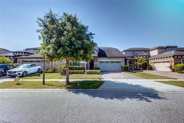 5118 Tiber Way, Saint Cloud, FL 34771 - view of front of house featuring a garage, stucco siding, and decorative driveway