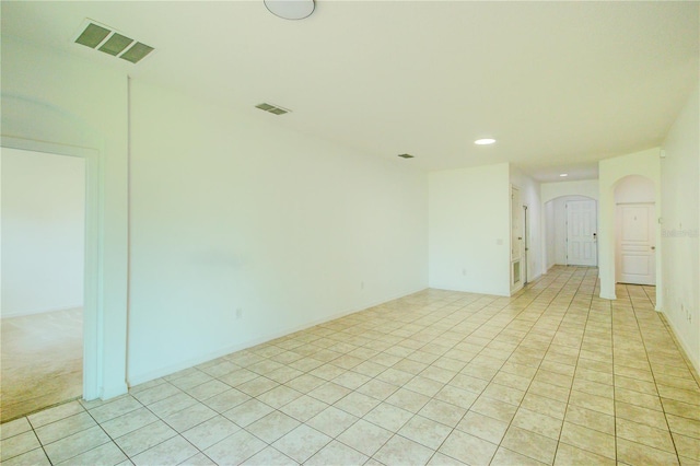 5118 Tiber Way, Saint Cloud, FL 34771 - unfurnished room with arched walkways, visible vents, light tile patterned flooring, and recessed lighting