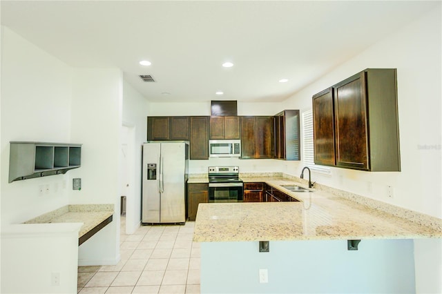 5118 Tiber Way, Saint Cloud, FL 34771 - kitchen featuring dark brown cabinets, a sink, a peninsula, appliances with stainless steel finishes, and visible vents