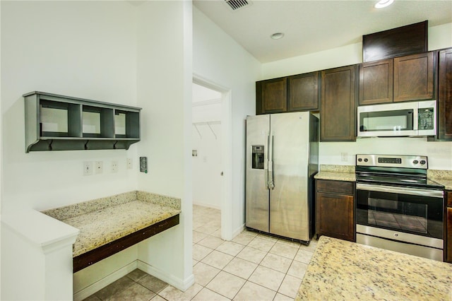 5118 Tiber Way, Saint Cloud, FL 34771 - kitchen with recessed lighting, light tile patterned flooring, baseboards, dark brown cabinetry, and appliances with stainless steel finishes