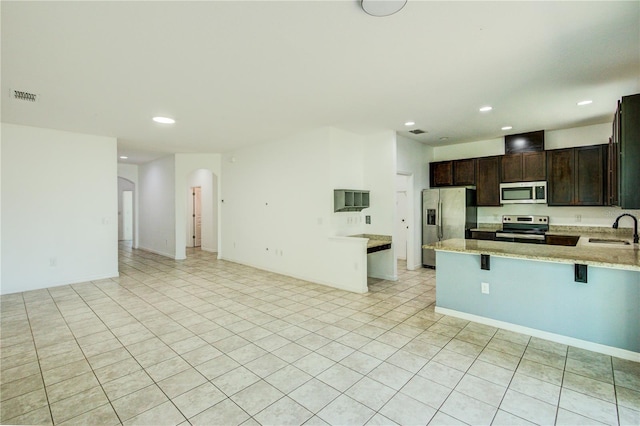5118 Tiber Way, Saint Cloud, FL 34771 - kitchen with a sink, open floor plan, appliances with stainless steel finishes, visible vents, and recessed lighting
