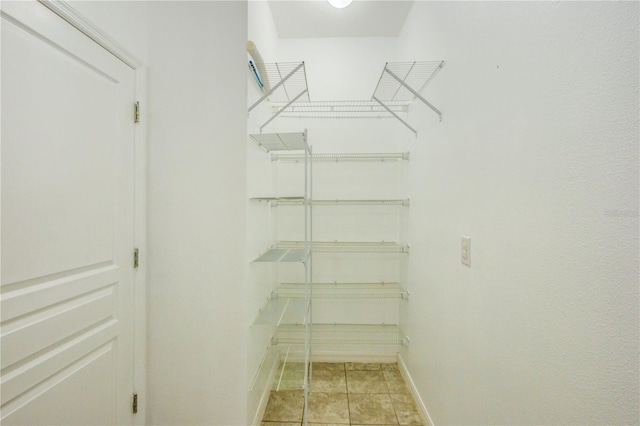 5118 Tiber Way, Saint Cloud, FL 34771 - walk in closet with light tile patterned floors