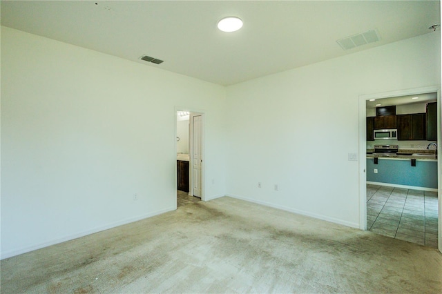 5118 Tiber Way, Saint Cloud, FL 34771 - spare room featuring light colored carpet, baseboards, and visible vents