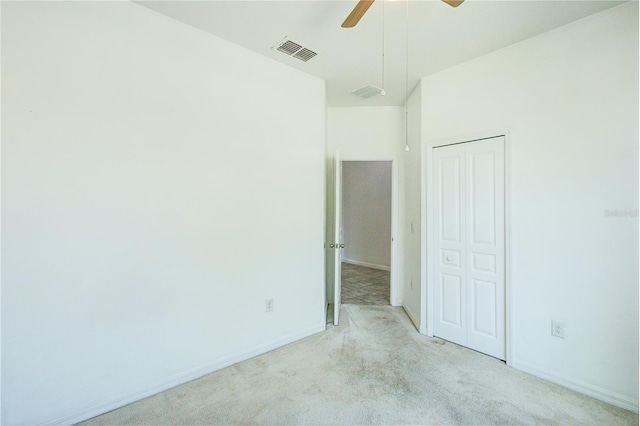 5118 Tiber Way, Saint Cloud, FL 34771 - unfurnished bedroom with baseboards, light carpet, visible vents, and a closet