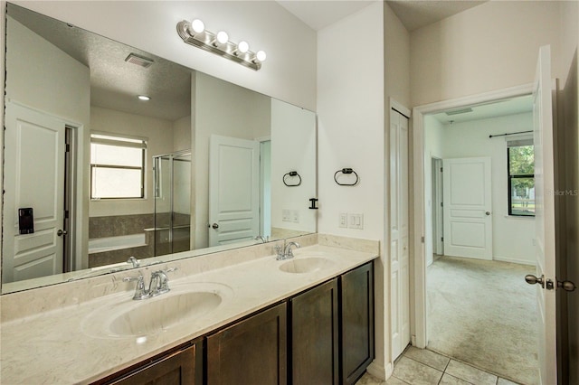 5118 Tiber Way, Saint Cloud, FL 34771 - bathroom featuring double vanity, a shower stall, tile patterned flooring, and a sink