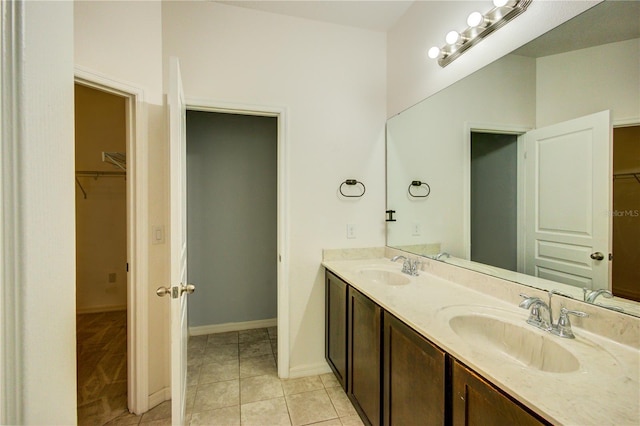 5118 Tiber Way, Saint Cloud, FL 34771 - full bathroom with tile patterned flooring, double vanity, a sink, and a walk in closet