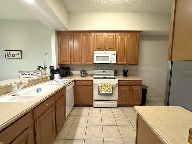9435 Myrtle Creek Ln Unit 304, Orlando, FL 32832 - kitchen with light countertops, white appliances, a sink, and light tile patterned floors