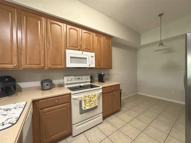 9435 Myrtle Creek Ln Unit 304, Orlando, FL 32832 - kitchen featuring light tile patterned flooring, white appliances, pendant lighting, light countertops, and baseboards
