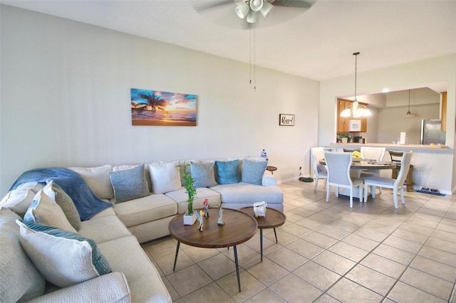 9435 Myrtle Creek Ln Unit 304, Orlando, FL 32832 - living area featuring ceiling fan with notable chandelier, baseboards, and light tile patterned floors