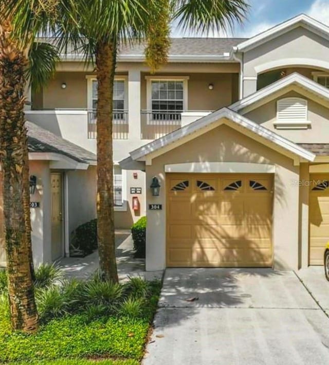 9435 Myrtle Creek Ln Unit 304, Orlando, FL 32832 - view of front of home with stucco siding, driveway, and a garage