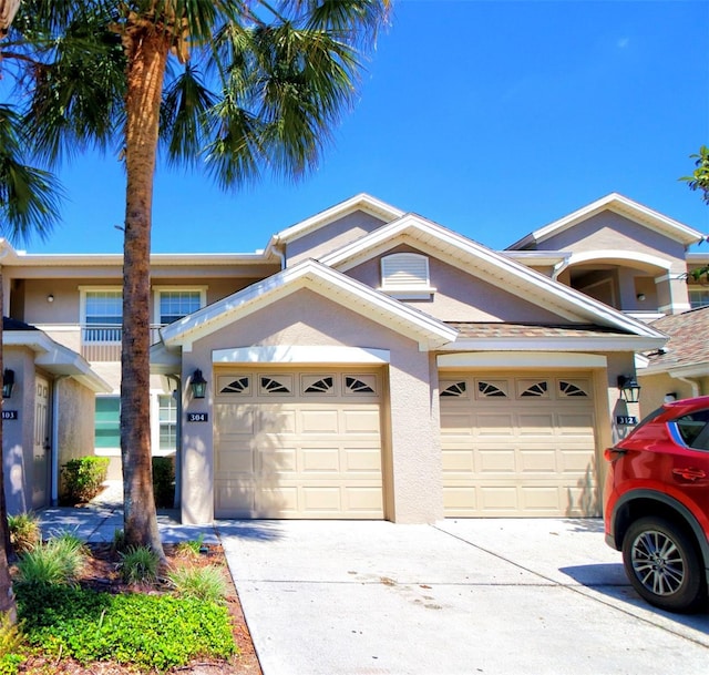 9435 Myrtle Creek Ln Unit 304, Orlando, FL 32832 - view of front of property featuring a garage, concrete driveway, and stucco siding
