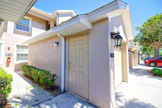 9435 Myrtle Creek Ln Unit 304, Orlando, FL 32832 - entrance to property with a garage, concrete driveway, and stucco siding
