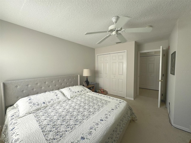 9435 Myrtle Creek Ln Unit 304, Orlando, FL 32832 - bedroom with visible vents, light carpet, a closet, a textured ceiling, and ceiling fan