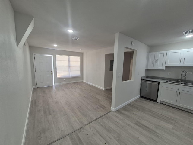 139 Arroyo Pkwy, Ormond Beach, FL 32174 - kitchen with dishwasher, visible vents, a sink, light wood-type flooring, and baseboards