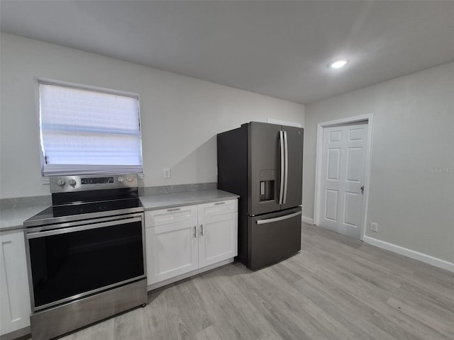 139 Arroyo Pkwy, Ormond Beach, FL 32174 - kitchen with white cabinets, light countertops, fridge with ice dispenser, light wood-type flooring, and stainless steel electric stove