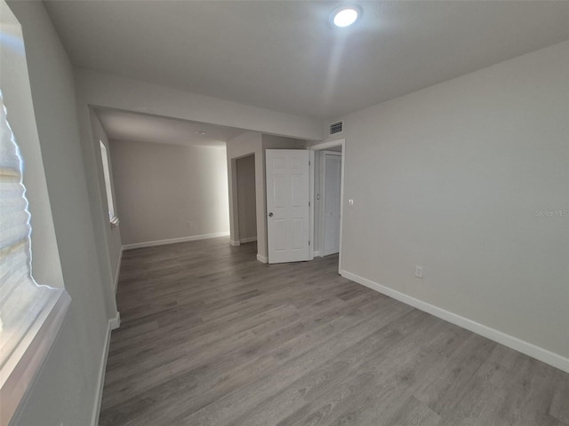 139 Arroyo Pkwy, Ormond Beach, FL 32174 - spare room featuring wood finished floors, visible vents, and baseboards