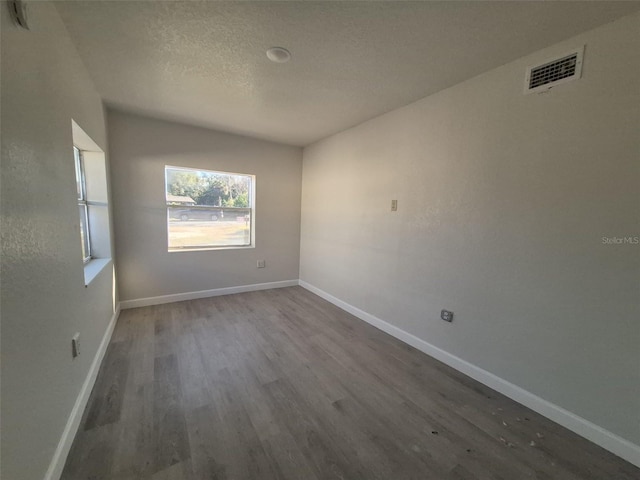 139 Arroyo Pkwy, Ormond Beach, FL 32174 - unfurnished room with baseboards, wood finished floors, visible vents, and a textured ceiling