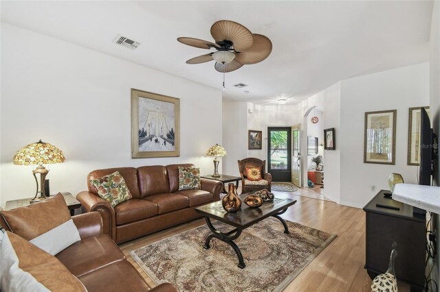 523 Shell Creek St, Poinciana, FL 34759 - living room with light wood finished floors, baseboards, a ceiling fan, and visible vents