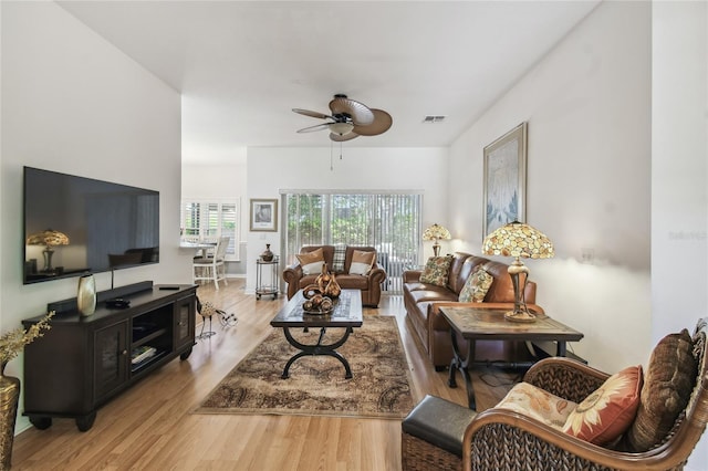 523 Shell Creek St, Poinciana, FL 34759 - living room featuring wood finished floors, visible vents, and a ceiling fan