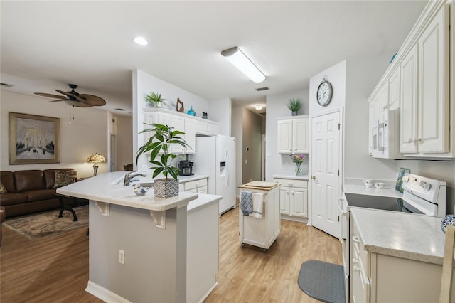 523 Shell Creek St, Poinciana, FL 34759 - kitchen featuring light wood-style flooring, a ceiling fan, open floor plan, and white appliances
