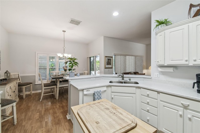 523 Shell Creek St, Poinciana, FL 34759 - kitchen with visible vents, a sink, white dishwasher, a chandelier, and white cabinetry