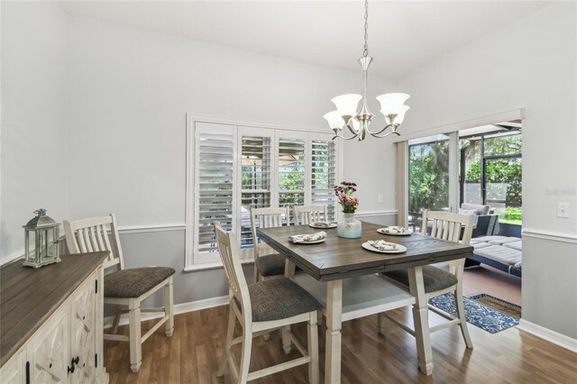 523 Shell Creek St, Poinciana, FL 34759 - dining space featuring baseboards, wood finished floors, and a chandelier