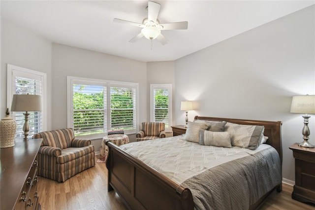 523 Shell Creek St, Poinciana, FL 34759 - bedroom with a ceiling fan, wood finished floors, and multiple windows