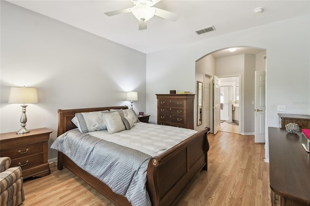 523 Shell Creek St, Poinciana, FL 34759 - bedroom featuring light wood-style flooring, visible vents, arched walkways, and connected bathroom