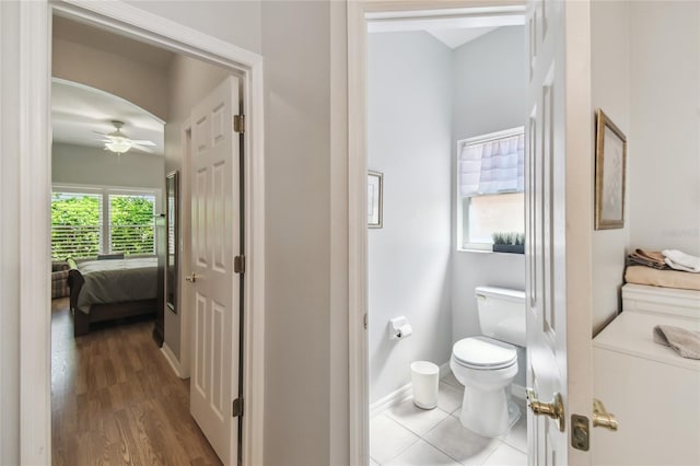 523 Shell Creek St, Poinciana, FL 34759 - ensuite bathroom featuring toilet, baseboards, a ceiling fan, wood finished floors, and connected bathroom
