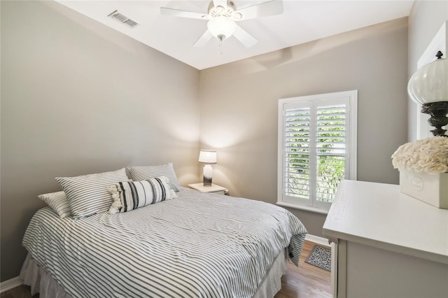 523 Shell Creek St, Poinciana, FL 34759 - bedroom with baseboards, wood finished floors, visible vents, and ceiling fan