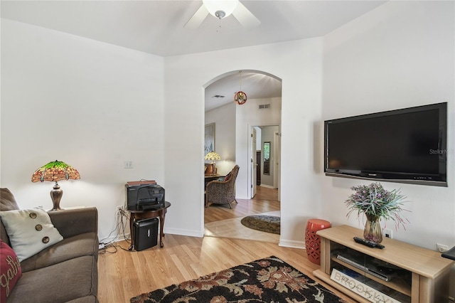 523 Shell Creek St, Poinciana, FL 34759 - living room with a ceiling fan, wood finished floors, arched walkways, baseboards, and visible vents