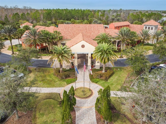 523 Shell Creek St, Poinciana, FL 34759 - view of front of house featuring a tile roof and a view of trees