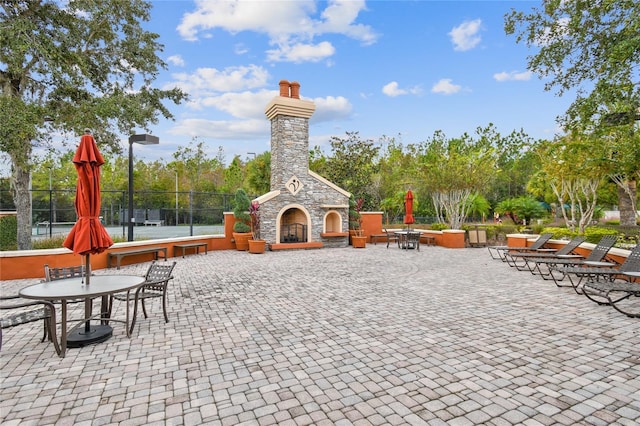523 Shell Creek St, Poinciana, FL 34759 - view of patio / terrace with an outdoor stone fireplace and fence