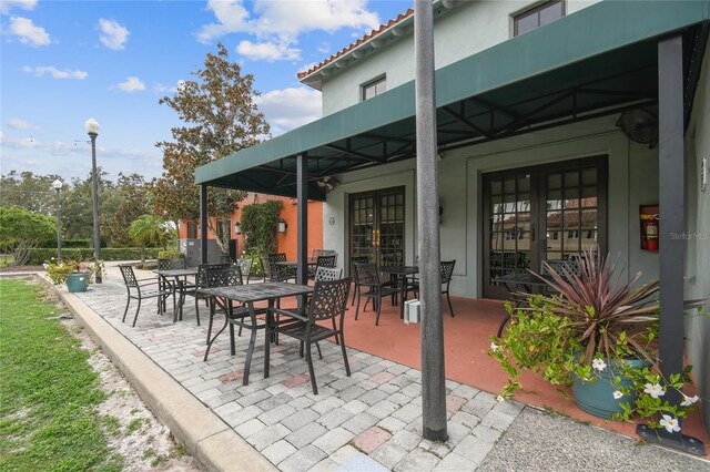 523 Shell Creek St, Poinciana, FL 34759 - view of patio featuring french doors and outdoor dining area