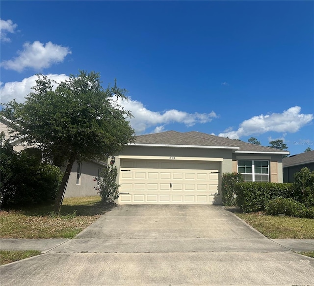 single story home with an attached garage, driveway, and stucco siding
