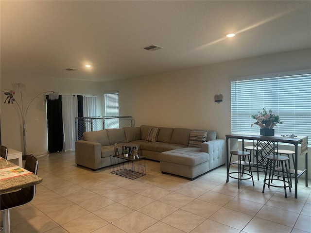 living room with visible vents, recessed lighting, and light tile patterned floors