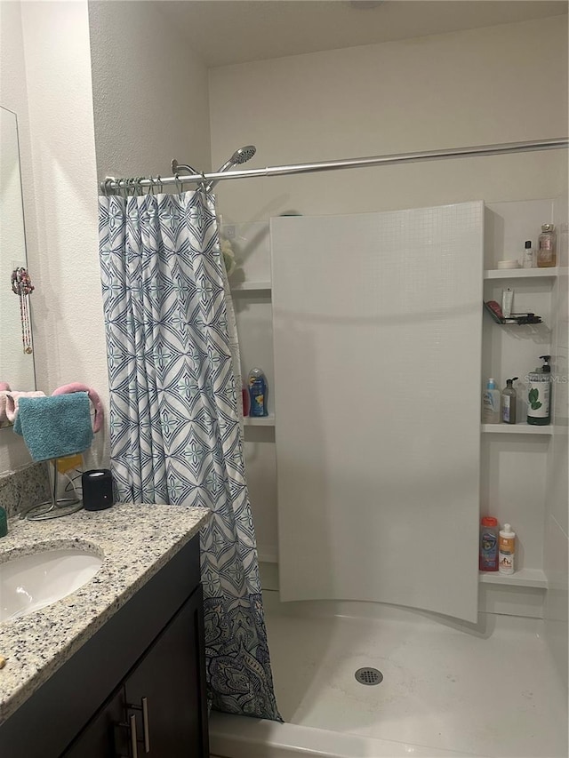 full bathroom with vanity and a stall shower