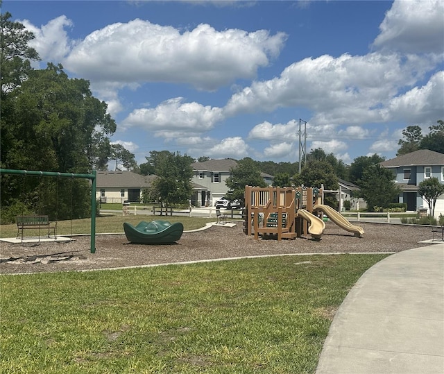 communal playground featuring a lawn