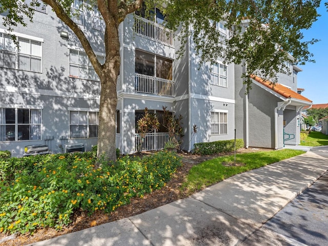18001 Richmond Place Dr Unit 126, Tampa, FL 33647 - view of front of property featuring stucco siding and a tiled roof