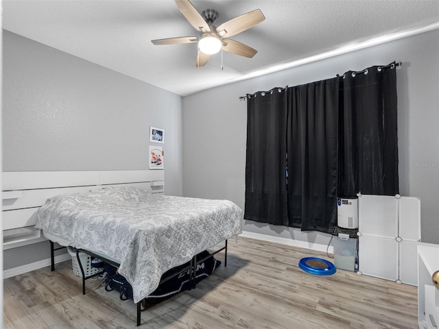 18001 Richmond Place Dr Unit 126, Tampa, FL 33647 - bedroom with wood finished floors and a ceiling fan