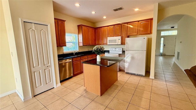 954 Hacienda Cir, Kissimmee, FL 34741 - kitchen with white appliances, arched walkways, healthy amount of natural light, a center island, and recessed lighting