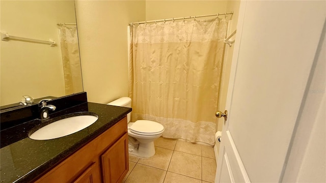 954 Hacienda Cir, Kissimmee, FL 34741 - bathroom with tile patterned floors, toilet, vanity, and a shower with curtain