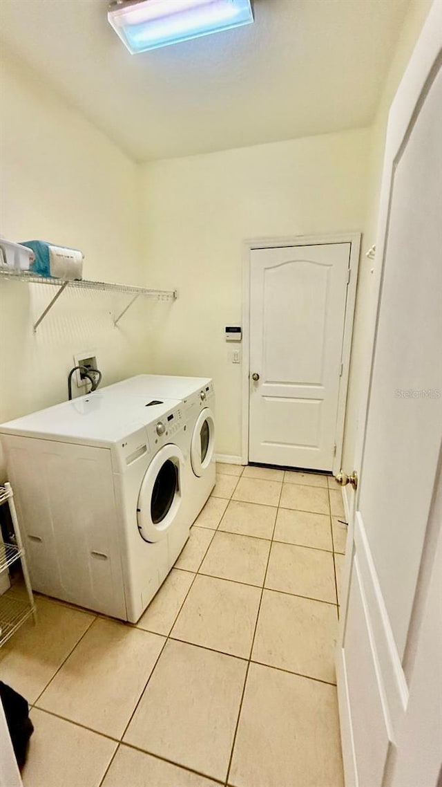 954 Hacienda Cir, Kissimmee, FL 34741 - laundry room featuring washer and dryer and light tile patterned floors