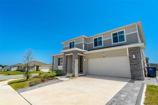 1003 Sugarwood St, Davenport, FL 33837 - traditional home featuring an attached garage, driveway, and stone siding