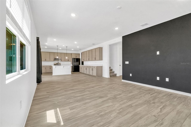 1003 Sugarwood St, Davenport, FL 33837 - unfurnished living room with recessed lighting, light wood-type flooring, visible vents, and baseboards