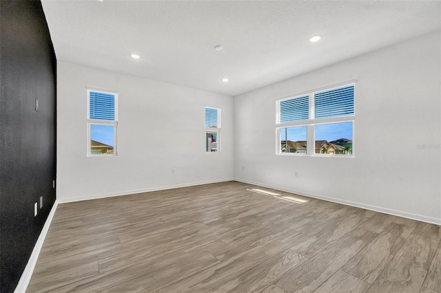 1003 Sugarwood St, Davenport, FL 33837 - spare room with baseboards, light wood finished floors, and recessed lighting