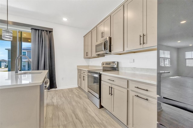 1003 Sugarwood St, Davenport, FL 33837 - kitchen featuring light countertops, recessed lighting, stainless steel appliances, and a sink