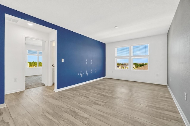 1003 Sugarwood St, Davenport, FL 33837 - empty room featuring baseboards, wood finished floors, and plenty of natural light