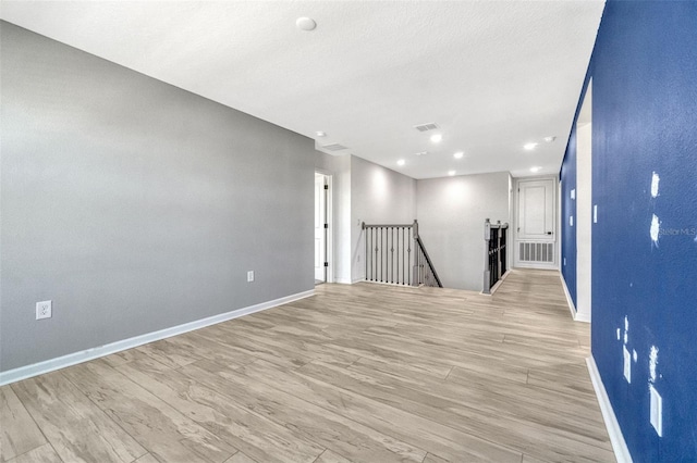 1003 Sugarwood St, Davenport, FL 33837 - unfurnished room with visible vents, baseboards, recessed lighting, and light wood-style floors