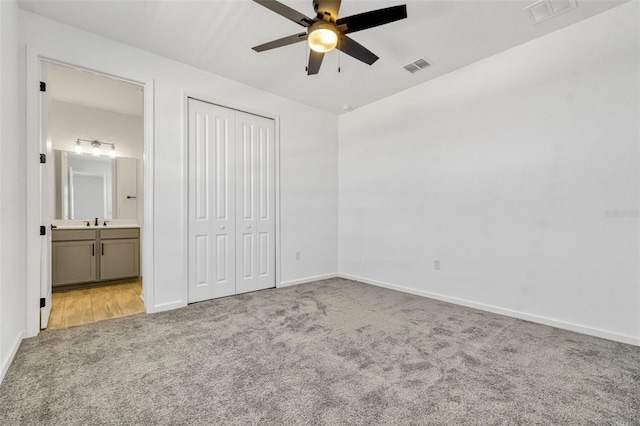 1003 Sugarwood St, Davenport, FL 33837 - unfurnished bedroom featuring baseboards, visible vents, a closet, and carpet flooring